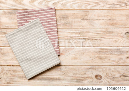 top view with gray kitchen napkin isolated on table background. Folded cloth for mockup with copy space, Flat lay. Minimal style top view with gray kitchen napkin isolated on table background. Folded cloth for mockup with copy space, Flat lay. Minimal style 103604612