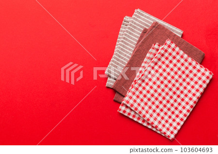 top view with red empty kitchen napkin isolated on table background. Folded cloth for mockup with copy space, Flat lay. Minimal style top view with red empty kitchen napkin isolated on table background. Folded cloth for mockup with copy space, Flat lay. Minimal style 103604693