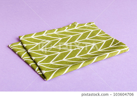 top view with green kitchen napkin isolated on table background. Folded cloth for mockup with copy space, Flat lay. Minimal style top view with green kitchen napkin isolated on table background. Folded cloth for mockup with copy space, Flat lay. Minimal style 103604706