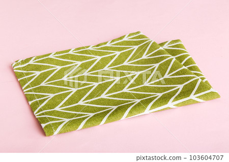 top view with green kitchen napkin isolated on table background. Folded cloth for mockup with copy space, Flat lay. Minimal style top view with green kitchen napkin isolated on table background. Folded cloth for mockup with copy space, Flat lay. Minimal style 103604707