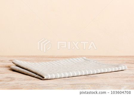 top view with gray kitchen napkin isolated on table background. Folded cloth for mockup with copy space, Flat lay. Minimal style top view with gray kitchen napkin isolated on table background. Folded cloth for mockup with copy space, Flat lay. Minimal style 103604708