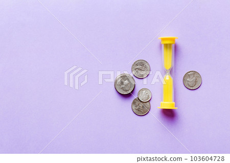 Deadline and time is money concept with hourglass and US coins currency. sand clock time for saving concept 103604728