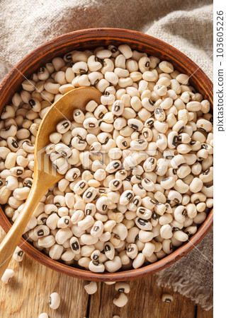 Raw black-eyed peas or beans close-up in a bowl. Vertical top view 103605226