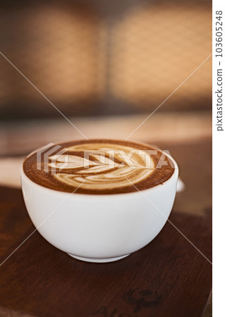 Selective focus cup of hot latte art coffee on wooden table Selective focus cup of hot latte art coffee on wooden table 103605248