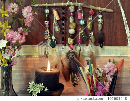 Close up of witchy decorations and burning tables on ritual altar table. Occult, esoteric and divination still life. Mystic background with vintage objects Close up of witchy decorations and burning tables on ritual altar table. Occult, esoteric and divination still life. Mystic background with vintage objects 103605448