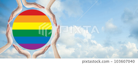 Human hands protect LGBT flag on blue sky with white clouds background 103607040