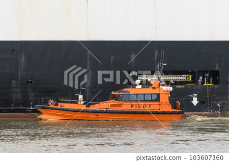 Pilot boat and cargo vessel at sea. Pilot embarkation. Pilotage. Pilot boat and cargo vessel at sea. Pilot embarkation. Pilotage. 103607360
