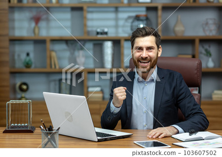 Portrait of mature senior businessman in office, man looking at camera and holding hands up super power and superhero gesture, successful investor using laptop inside building. Portrait of mature senior businessman in office, man looking at camera and holding hands up super power and superhero gesture, successful investor using laptop inside building. 103607502