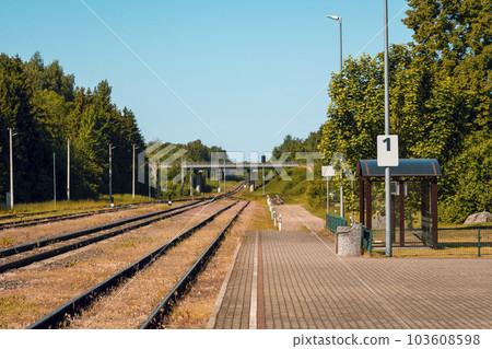 Platform of a train station with empty railway tracks Platform of a train station with empty railway tracks 103608598
