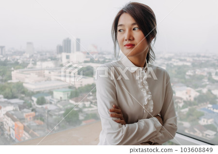Business woman inteupreneur standing by the windows with city veiw. 103608849