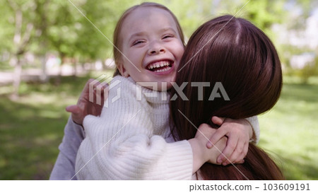 happy family park. mother hugs running cheerful child. portrait kid child girl smile. happy affectionate mother park proroda walk daughter. adoptive parent. adorable little child girl hugging her mom 103609191