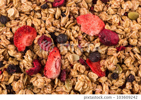 Muesli oat cereals close up background with dry fruits 103609242