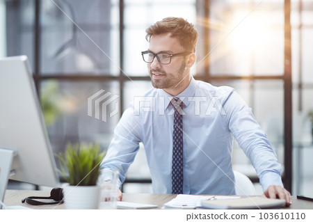 Young businessman working at modern glass office Young businessman working at modern glass office 103610110