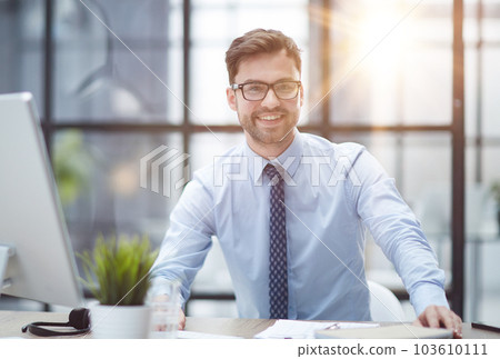 Young businessman working at modern glass office Young businessman working at modern glass office 103610111