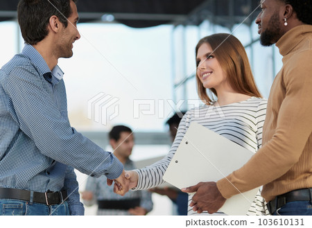 Woman distributing ID cards to professionals for seminar Woman distributing ID cards to professionals for seminar 103610131