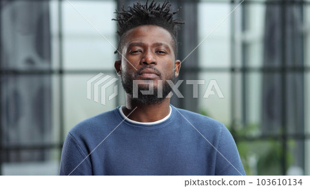 Confident black business man looking at camera with serious expression Confident black business man looking at camera with serious expression 103610134