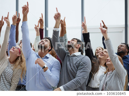 happy group of diverse young people holding their hands up 103610845