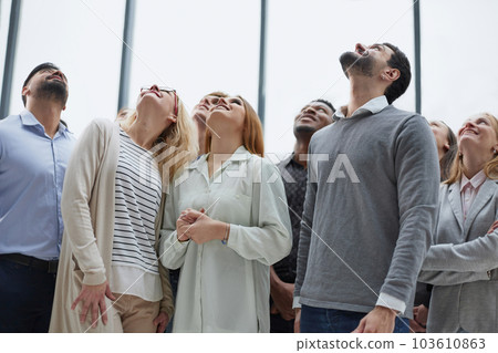 Active multiethnic male and female audience looking up Active multiethnic male and female audience looking up 103610863