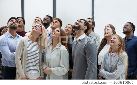 Active multiethnic male and female audience looking up Active multiethnic male and female audience looking up 103610865