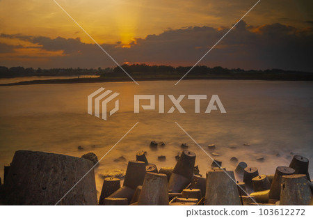 Tetrapods or breakwaters on the Glagah Beach, Kulonprogo, Indonesia during sunrise. 103612272