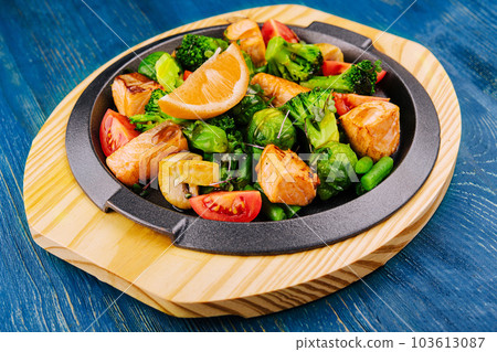 Grilled salmon with vegetables in a pan 103613087