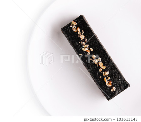 Small chocolate cake on a white plate 103613145