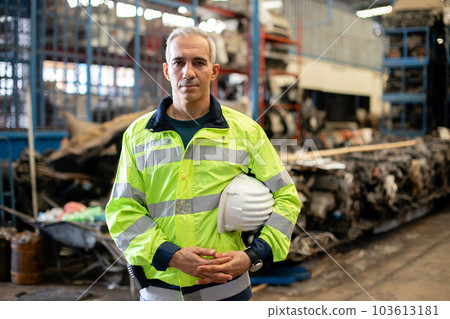 Portrait of man professional engineering arms crossed worker wear uniform holding hard hat 103613181