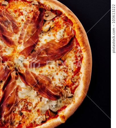Pizza with jamon, cheese and mushrooms on black 103613222