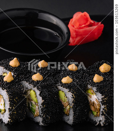 Sushi rolls with tuna and caviar on black plate Sushi rolls with tuna and caviar on black plate 103613269