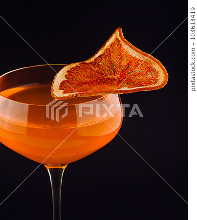 Alcoholic cocktail in a glass with a slice of orange 103613419