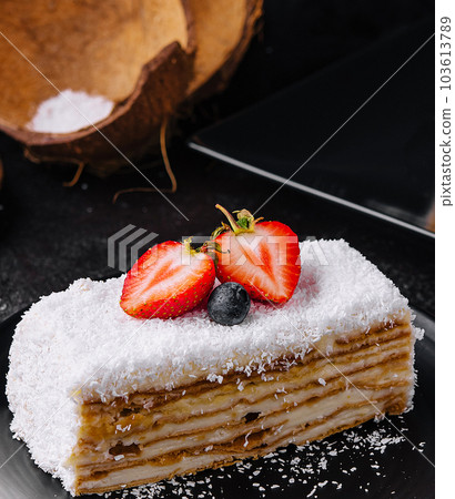 Coconut Cake slice with strawberries and blueberries Coconut Cake slice with strawberries and blueberries 103613789