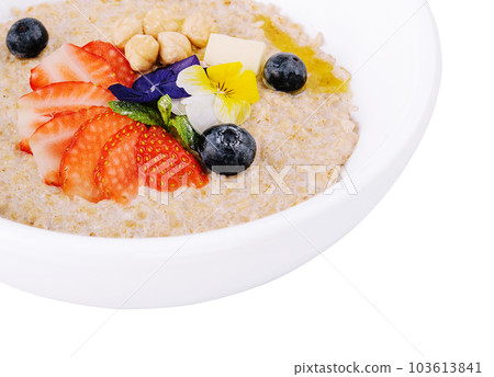 Oatmeal with strawberries, blueberries and hazelnuts Oatmeal with strawberries, blueberries and hazelnuts 103613841