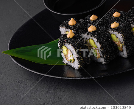 Sushi rolls with tuna and caviar on black plate 103613849