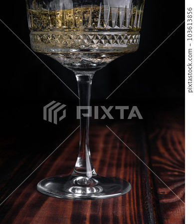 Glass of champagne with splash, isolated on black background Glass of champagne with splash, isolated on black background 103613856