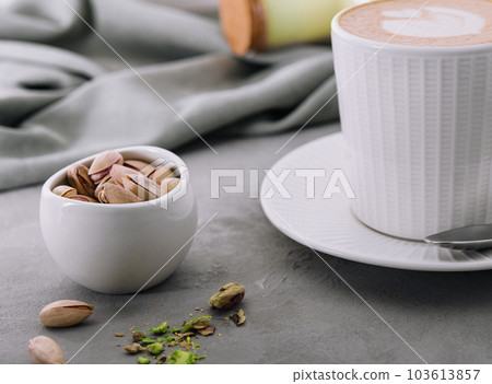 Cup of heart latte art and pistachios Cup of heart latte art and pistachios 103613857