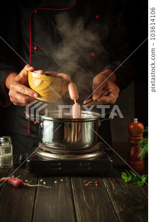 For lunch need to cook delicious meat sausages. Chef in the kitchen at work. Menu idea for a hotel or restaurant. For lunch need to cook delicious meat sausages. Chef in the kitchen at work. Menu idea for a hotel or restaurant. 103614106