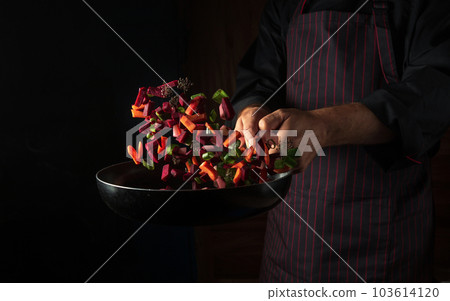 Cooking vegetables by chef hands on dark background copy space. Food concept. Vegetable menu for the hotel Cooking vegetables by chef hands on dark background copy space. Food concept. Vegetable menu for the hotel 103614120
