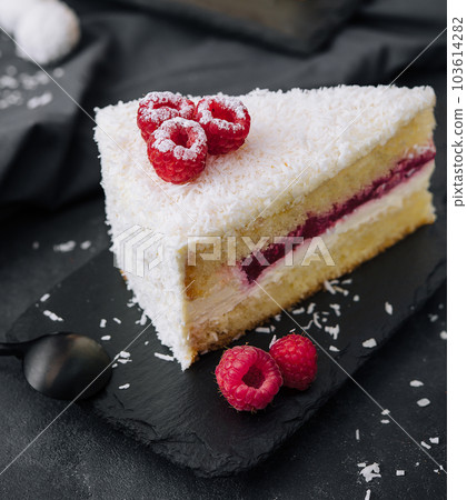 Winter cake with white cream decorated raspberries 103614282