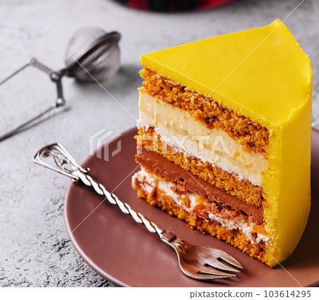 Tasty mango mousse cake on plate 103614295