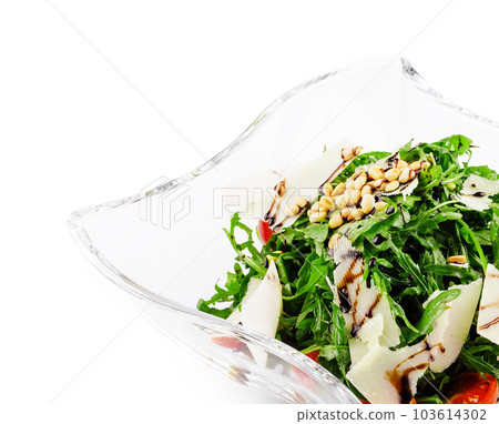 Arugula salad with sunflower kernels and sprinkled with grated parmesan 103614302
