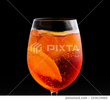 glass of aperol spritz cocktail on black background 103614460