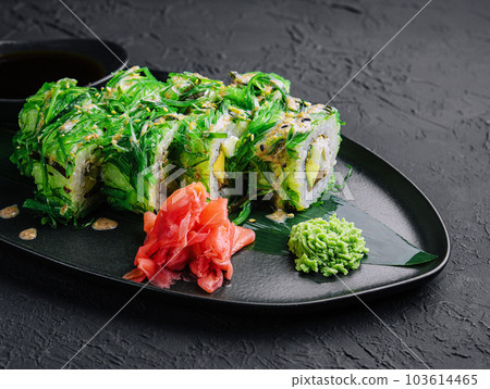 set sushi rolls in seaweed on black plate 103614465