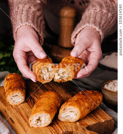 Woman cooking Vertuta or placinta with cottage cheese Woman cooking Vertuta or placinta with cottage cheese 103614540