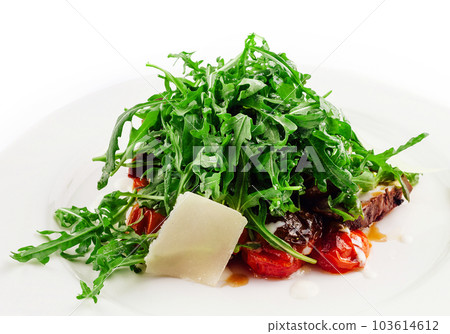 Italian beef tagliata salad with wild rocket, cherry tomatoes and parmesan cheese 103614612