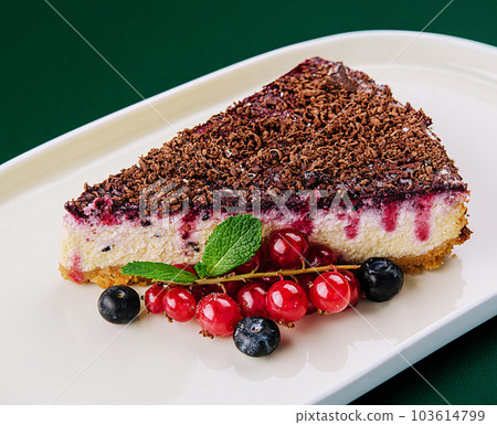 vanilla cheesecake with chocolate sauce and berries vanilla cheesecake with chocolate sauce and berries 103614799