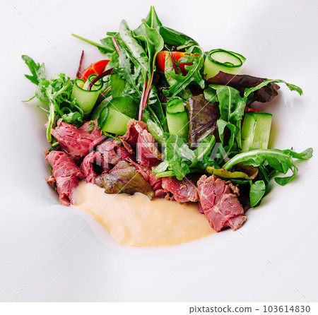 Meat Carpaccio with Rocket Salad on plate 103614830