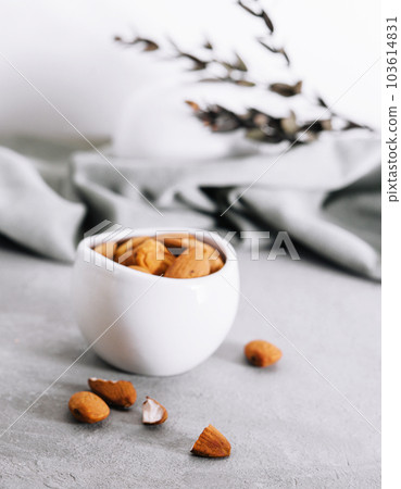 almonds in a white ceramic bowl 103614831