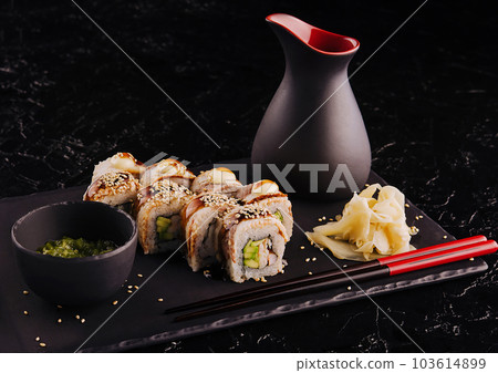 Sushi set canada roll with eel on black stone 103614899