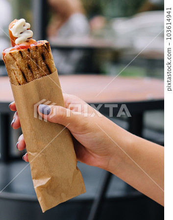 French hot dogs in woman`s hand 103614941