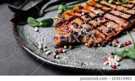 Fried juicy steaks with herbs and spices on plate Fried juicy steaks with herbs and spices on plate 103614965